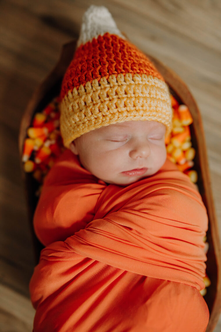 newborn baby girl in candy corn