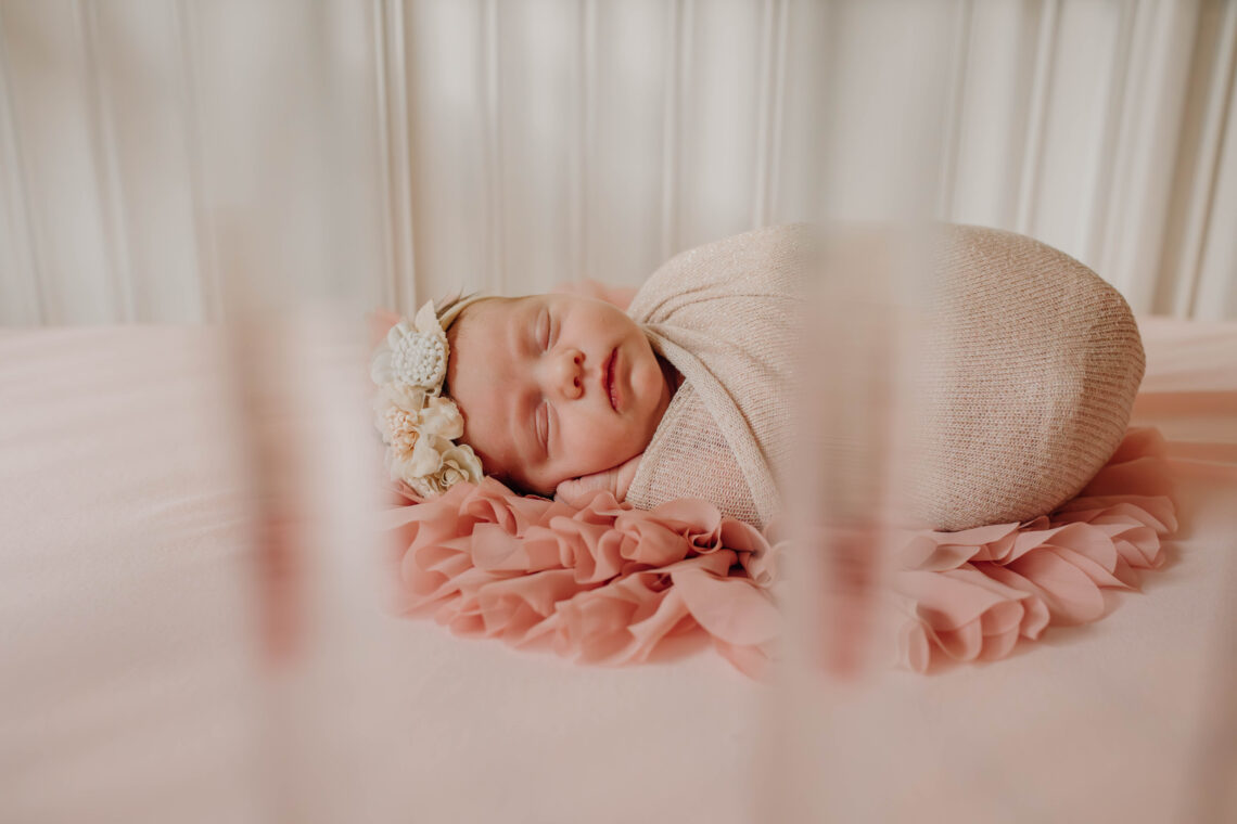 newborn baby girl in crib